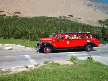 Red tour bus on Highway to the Sun in Glacier NP