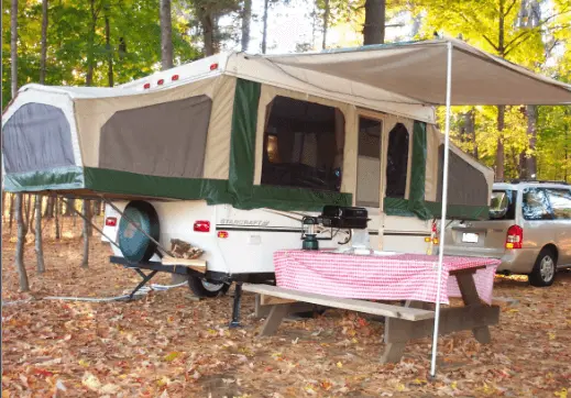 Camping with a pop-up camper in the woods